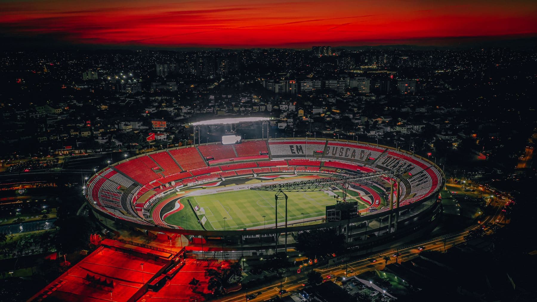A stadium lit up at dusk